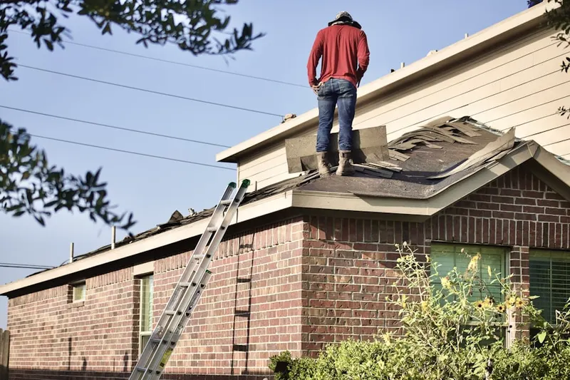 Professional roofer working on a residential roof in Forest Hill Farms